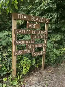 A sign post at Trail Blazers saying 'Trail Blazers are nature detectives, explorers, architects, den builders, risk takers, growers'.